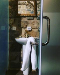 a bathroom with a sink and a towel at Stone Cellars in Douma