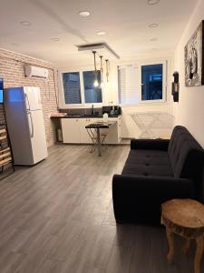 a living room with a couch and a kitchen at Casa Mare Oureah in Mazagran