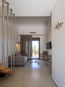 a living room with a couch and a table at Elaionas Houses in Skala Potamias