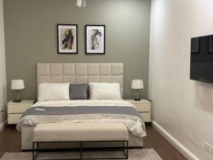 a bedroom with a large bed with two night stands at TM Homes in Abuja