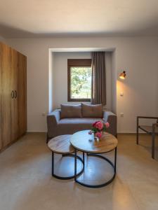 a living room with a couch and a table at Elaionas Houses in Skala Potamias