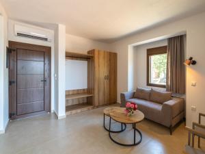 a living room with a couch and a table at Elaionas Houses in Skala Potamias