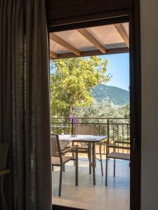 a table and chairs on a balcony with a view at Elaionas Houses in Skala Potamias