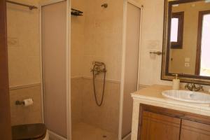 a bathroom with a shower and a sink at Skalopetra in Pylos +20 photos