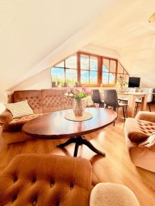 a living room with a table and a couch at Ubytování Carmen in Česká Skalice