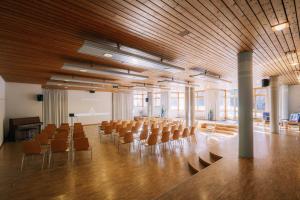 a large room with chairs and a stage in it at Haslibergoase in Hasliberg +38 photos