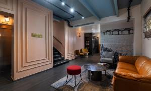 a living room with a couch and a table at Dizengoff Avenue Boutique Hotel - by Echo Hotels in Tel Aviv