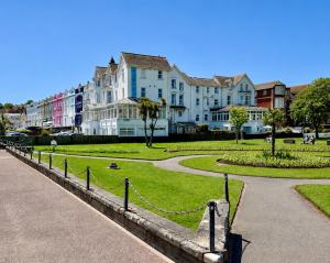 a row of houses in a park with a chain at Fiveway Apartments in Paignton