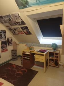 a bedroom with a desk and a television on the ceiling at PROCHE CIRCUIT 24H Le Mans in Guécélard