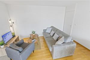 a living room with a couch and two chairs at Appartement central et confortable in Crans-Montana