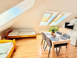 a living room with a table and chairs and skylights at Ubytování Carmen in Česká Skalice