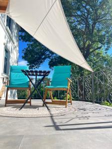 two chairs and an umbrella on a patio at In the nature in Vroutek