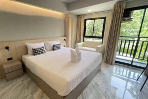 a bedroom with a large white bed and windows at Baan Thanakul Suvarnabhumi in Ban Khlong Nong Pru +48 photos