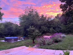 a sunset over a garden with a gazebo at In the nature in Vroutek