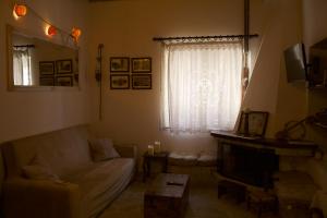 a living room with a couch and a window at Skalopetra in Pylos