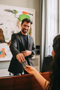 a woman is handing a man a knife at Torel Private Collection in Porto