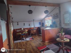 a living room with a couch and a table at Departamento con tinaja in Llanquihue