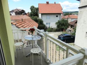 a balcony with a table and chairs and a view at Vila Jenic in Soko Banja