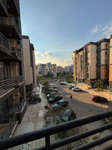 a view of a parking lot with cars parked at Rent house b8 in Madinaty