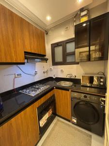 a kitchen with a stove and a sink at Rent house b8 in Madinaty
