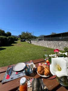 a picnic table with bread and pastries on it at Gestiona2R - Casa Dos Carmenes, caminando a la playa, ideal familias in Llanes