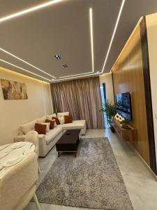 a living room with a couch and a tv at Rent house b8 in Madinaty