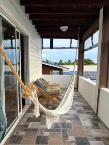 a hammock on the porch of a house at Solea by The Sea in Roatán +20 photos