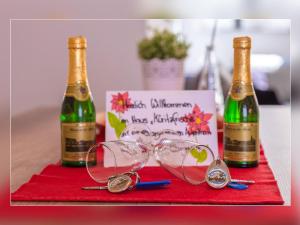 two bottles of champagne and glasses on a table at Fewo Müritzfrische 2 in Waren