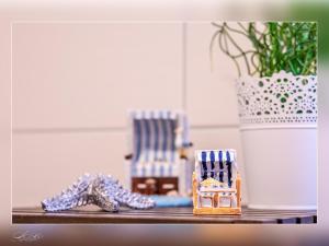 a shelf with figurines of chairs and a potted plant at Fewo Müritzfrische 2 in Waren +9 photos