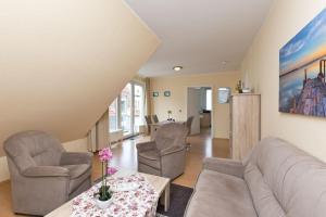 a living room with a couch and chairs and a table at Am Seeufer 60 Fewo 605 in Waren