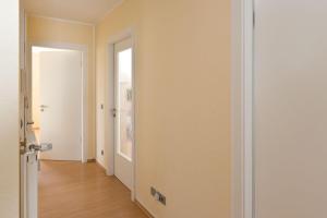 an empty room with a door and a hallway at Am Seeufer 60 Fewo 605 in Waren +10 photos