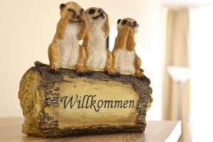 a group of meerkats sitting on top of a sign at Am Seeufer 60 Fewo 605 in Waren