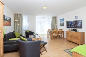 a living room with a couch and a dining room at Am Seeufer 59b Fewo 3 in Waren