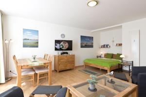 a living room with a bed and a table at Am Seeufer 59b Fewo 3 in Waren