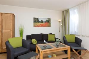 a living room with a couch and two chairs and a table at Am Seeufer 59b Fewo 3 in Waren