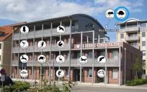 a building with clocks on the side of it at Hafendomicil Appartement WH05 - Maus in Waren