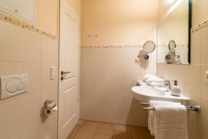 a white bathroom with a sink and a mirror at Hafendomicil Appartement WH12 - Specht in Waren