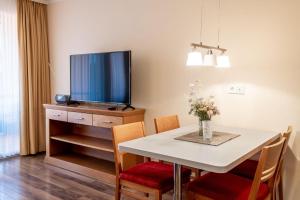 a dining room with a table and a tv at Hafendomicil Appartement WH06 - Hase in Waren