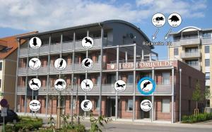 a building with clocks on the side of it at Hafendomicil Appartement WH06 - Hase in Waren