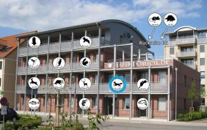 a building with clocks on the side of it at Hafendomicil Appartement WH07 - Fuchs in Waren