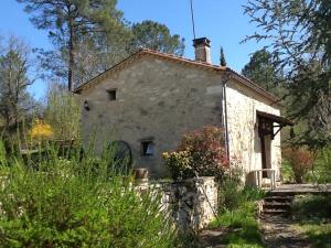 a small stone house in the middle of a garden at Les Mialles in Prayssac