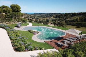 an image of a swimming pool in a yard at Villa Pietrarosa by MMega in Cascina Monte Serico