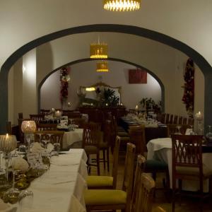 a dining room with tables and chairs and a large archway at VillaGrancassa Hotel Relais in San Donato Val di Comino