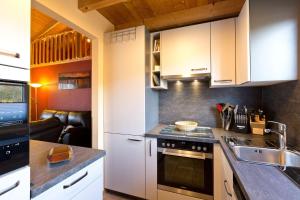 a kitchen with white cabinets and a sink at Ferienhaus Jabel 28 in Jabel