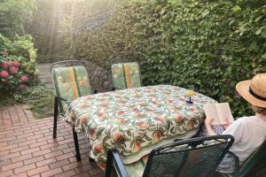 a person sitting at a table with a table cloth on it at UG-Birke in Göhren-Lebbin