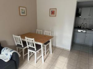 a kitchen with a wooden table and four chairs at UG-Buche in Göhren-Lebbin