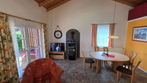 a living room with a table and a tv at Ferienhaus Jabel 30 in Jabel