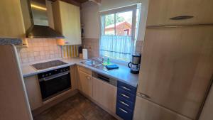 a small kitchen with a sink and a window at Ferienhaus Jabel 30 in Jabel