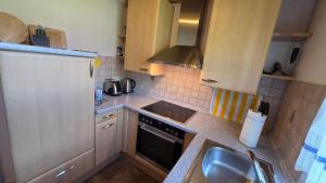 a small kitchen with a sink and a stove at Ferienhaus Jabel 30 in Jabel +15 photos