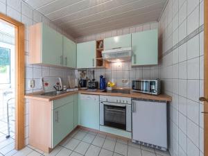 a kitchen with mint green cabinets and a sink at Groot Huus in Lärz
